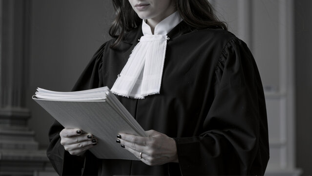 Lawyer in robes reading a document