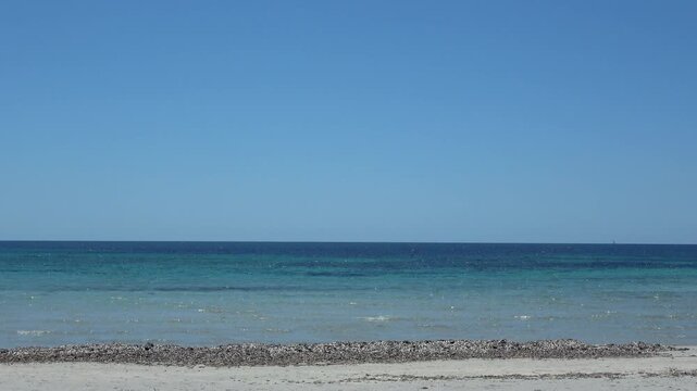 Clear ocean water washing tranquil sandy beach