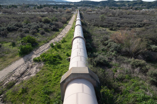 View of large water pipe crossing a river valley in Southern California.