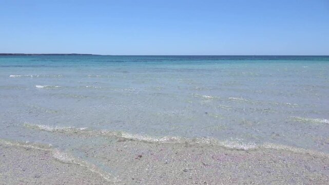 Clear turquoise sea water with blue sky horizon