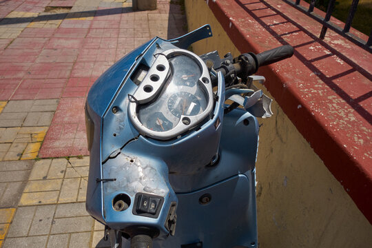 Broken steering wheel and instruments from a scooter.