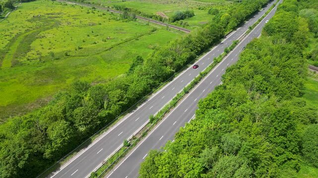 Aerial Drone View of A2 Motorway Parallel to Railway Line Through Lush Green Fields Hambrook Kent UK