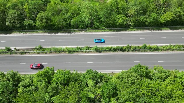 Bird&rsquo;s Eye Aerial Drone View of A2 Motorway Traffic Flowing Through Dense Green Woodland Hambrook Kent UK