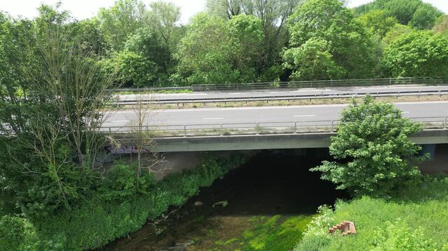 Aerial View of A2 Motorway Concrete Bridge Over Green Stream in Lush Woodland Hambrook Kent UK