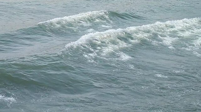 Close-up POV shot of churning white foam wake from a moving vessel on open sea. Perfect for travel, cruise, maritime, adventure, and transition background use.