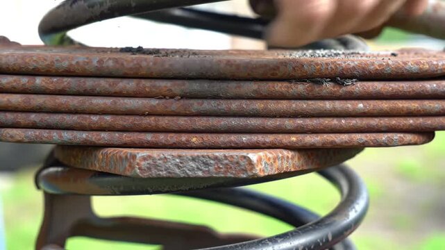 Close up of rusty leaf spring and coil spring suspension system.