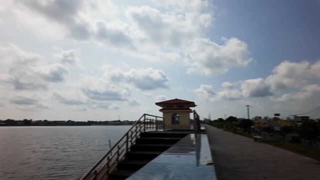 Visitors walk along the path at Cong Vien ven ho Ba To in Vung Tau, Vietnam. The sun shines bright in the sky.