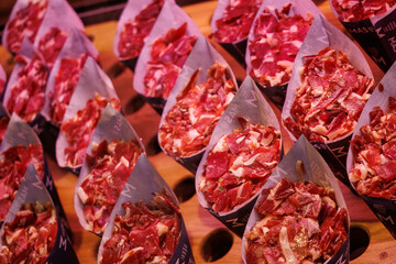 Obraz premium Assorted tapas with slices of jamon at Mercado de San Miguel in Madrid, Spain.