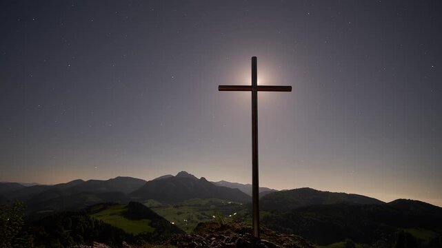 Night Timelapse of Christian Cross on Mountain Summit Moonrise to Milky Way Over Mountain Landscape