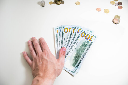 Money in hands on a plain background, saving money for business development