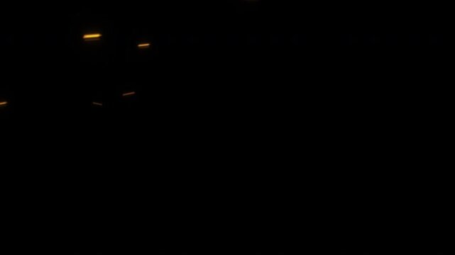 A single bright flame from a lighter ignites in the pitch black darkness.