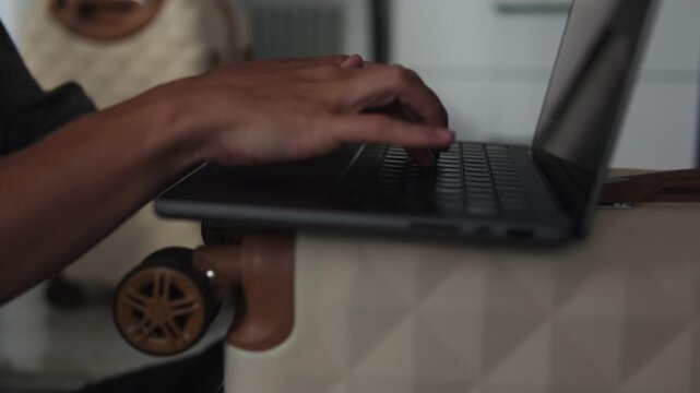 Hands typing on laptop placed on suitcase, closeup of remote freelancer working while traveling, fast paced digital nomad lifestyle, portable workspace and constant work on the move
