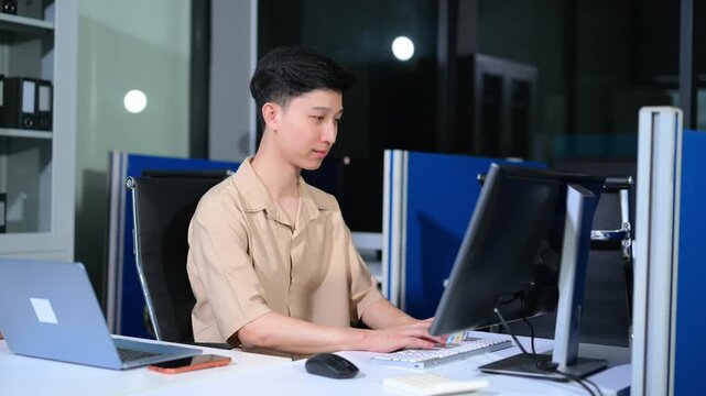 programmer hands typing code on laptop keyboard at night office