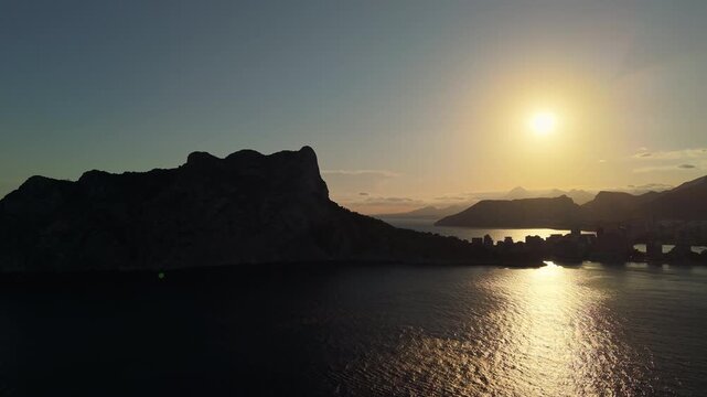 Aerial sunrise over Penon de Ifach silhouette and Calpe bay on Costa Blanca Spain