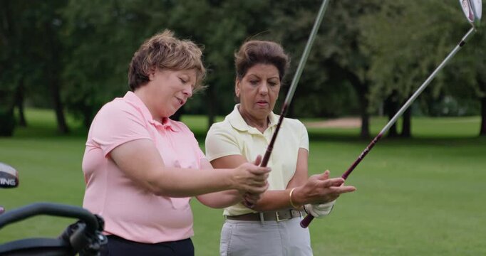 Golf course, instructor teaching woman and club at field, nature or outdoor for help in lesson. Golfers, coach and person learning hold driver, healthy exercise and conversation, training or sports