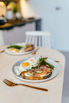 Healthy Breakfast With Eggs Salmon Toast And Asparagus On Dining Table