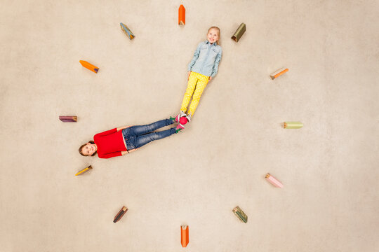 Girls forming clock needles