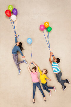 Children flying away on balloons
