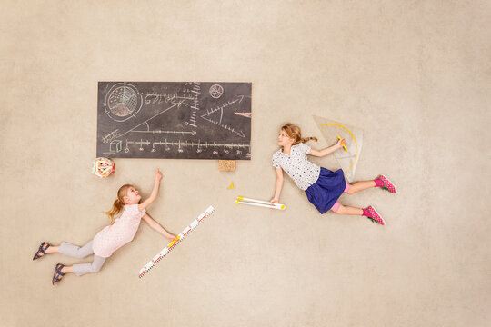 School kids calculating on blackboard