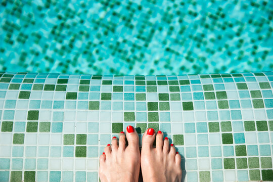 Woman's feet at poolside