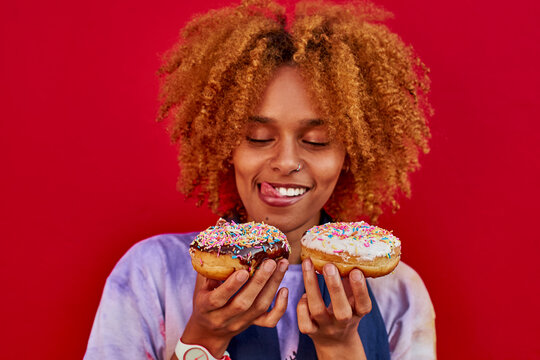 Woman choosing which donut to eat