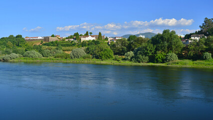 Obraz premium Monção and its walls, in Portugal, and the River Miño, the natural border with Spain, on a late spring day.