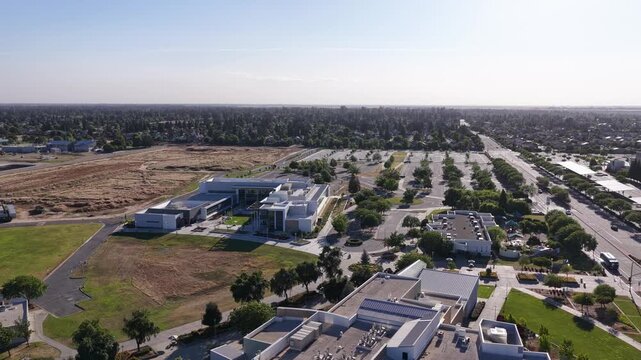 Drone perspective of the modern campus buildings and grounds of Clovis Community College in Fresno, California, showcasing its architecture and surrounding suburban landscape