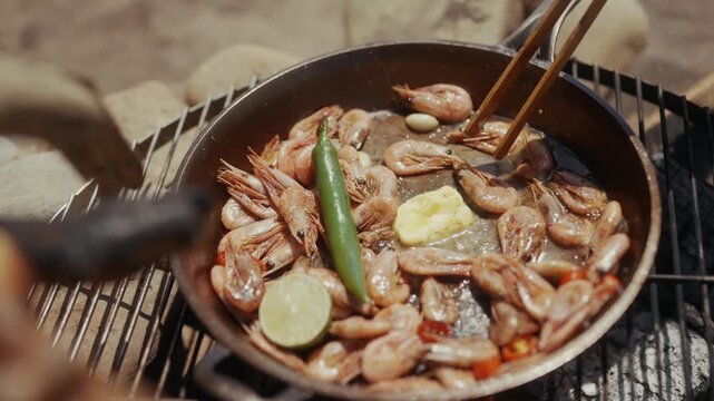 Cooking shrimp, chili, and lime in a cast iron pan