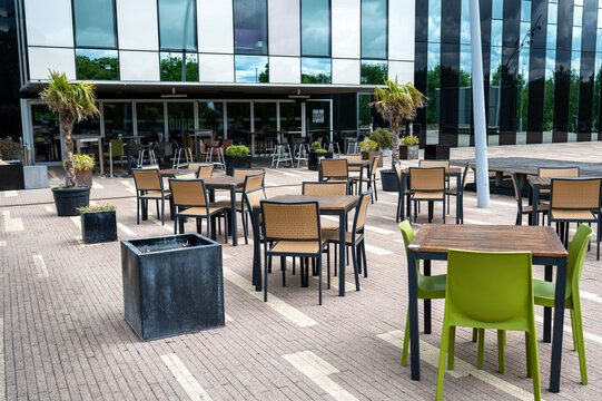 Corby, United Kingdom - June 9, 2025: Outdoor seating area outside Qube Cafe Bar in Corby town centre