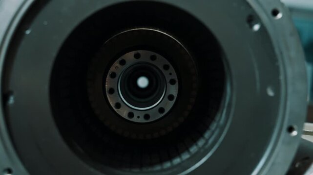 Close-up perspectives of a precision electric motor assembly highlighting a circular stator with copper windings, a concentric rotor hub, and a machined mounting flange.