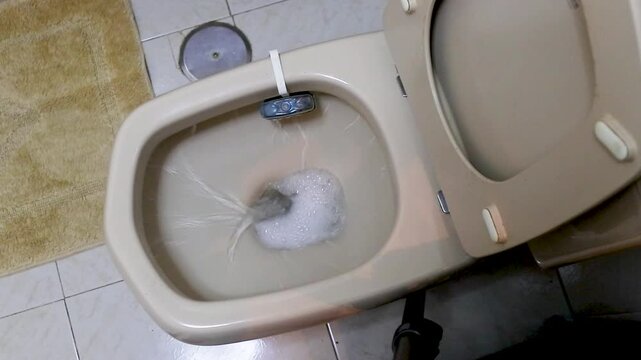 emptying the cistern water into the toilet