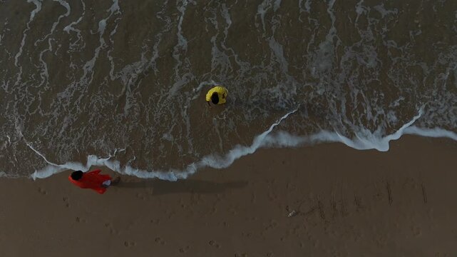 Aerial perspective of people enjoying and having fun on the sandy beach of Gomti Ghat in Dwarka, Gujarat.