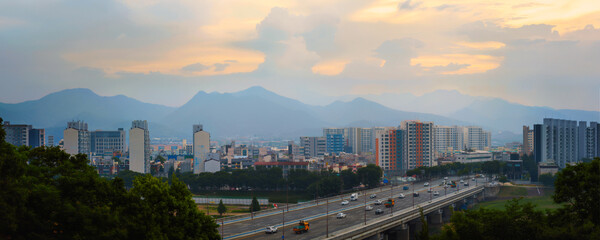 Fototapeta premium Daegu City sunrise panoramic landscape along the Geumho River and Bridge with Palgong‑san Mountain in the distant background in Gyeongsangbuk‑do, South Korea