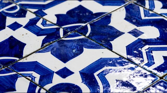 Macro detail of blue and white ceramic tile pattern with pan camera