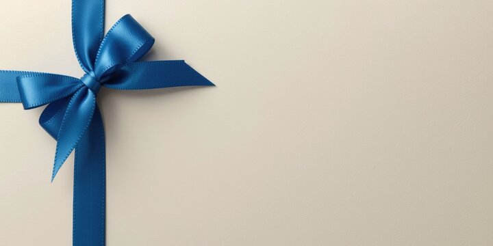 Greeting card featuring a blue satin ribbon border and gift box accent