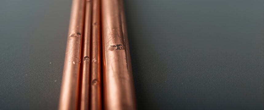 Electrical grounding rods in copper close up with copy space to avoid short circuits