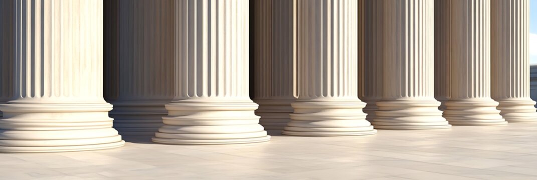 View of classical stone column bases and pavement with sunlight and blue sky.