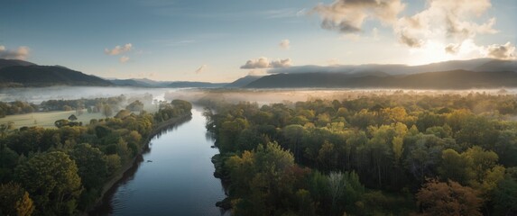 Obraz premium Drone image showing lush river landscape and mist filled mountains in calm weather