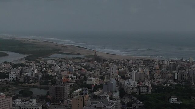 Wide aerial view of Dwarka city and the iconic Dwarkadhish Temple under cloudy sky
