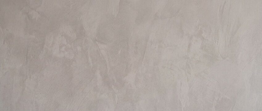 The background of the polished smooth cement surface is a warm gray color.