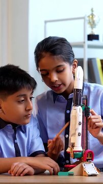 Indian School Kids Learning Space Rocket Technology Using 3D Model in Classroom While Wearing Uniforms, Engaging Education and Scientific Exploration During Academic Session Focused on Aerospace