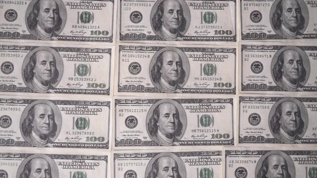 Top view of US one hundred dollar bills pattern. Financial background.