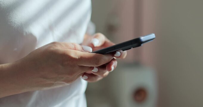 Close-up of young women hand. Hand of woman using texting mobile smartphone or chatting. Reading social media internet, typing text or shopping online.