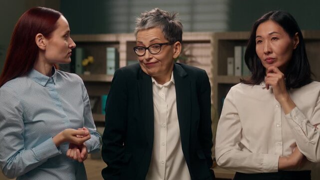 Business team multiethnic three women thinking shrugging shoulders Asian woman coming up with idea in office different ages businesswomen multiracial females think shrug Korean female create solution