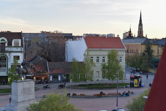 Novi Sad, Serbia - April 13 2026: Elevated wide view of Trg Republike (Republic Square) featuring the King Peter I monument and the Name of Mary Church spire at sunset