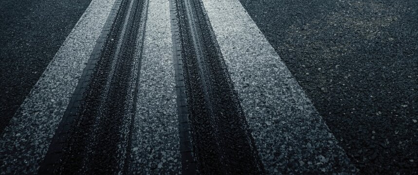 Close up of tire skid streaks on asphalt after rapid deceleration