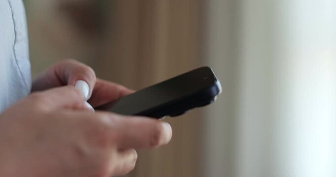 Hand of woman using texting mobile phone or chat. Close up of woman hand.