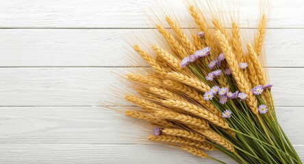 Obraz premium Greeting card design featuring a bouquet of ripe yellow wheat with purple and white flowers on a white wooden surface