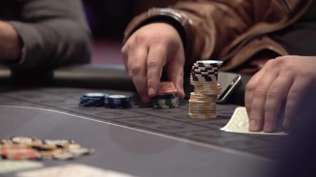 Casino footage showing a poker player folding a hand during a Texas Hold&rsquo;em game. Gambling, betting, poker strategy and casino entertainment concept.