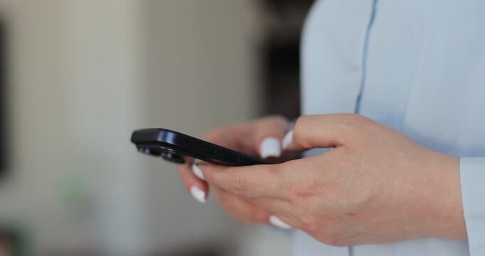 Hand of woman using texting mobile phone or chat. Close up of woman hand.